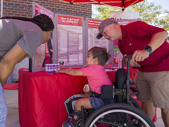 Boy in wheelchair selects prize from DEC booth at 2018 event
