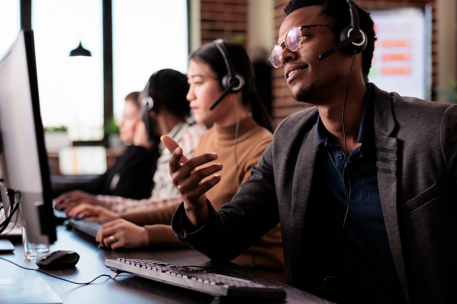 employees working at their computers with headsets on in a call center