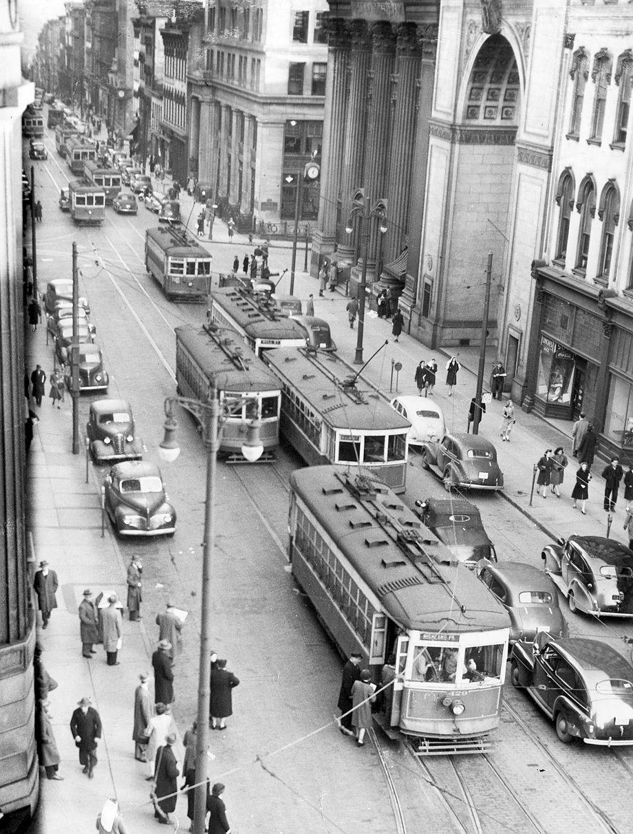 this image contains a black and white photo of the streetcars along Broad street in Richmond VA