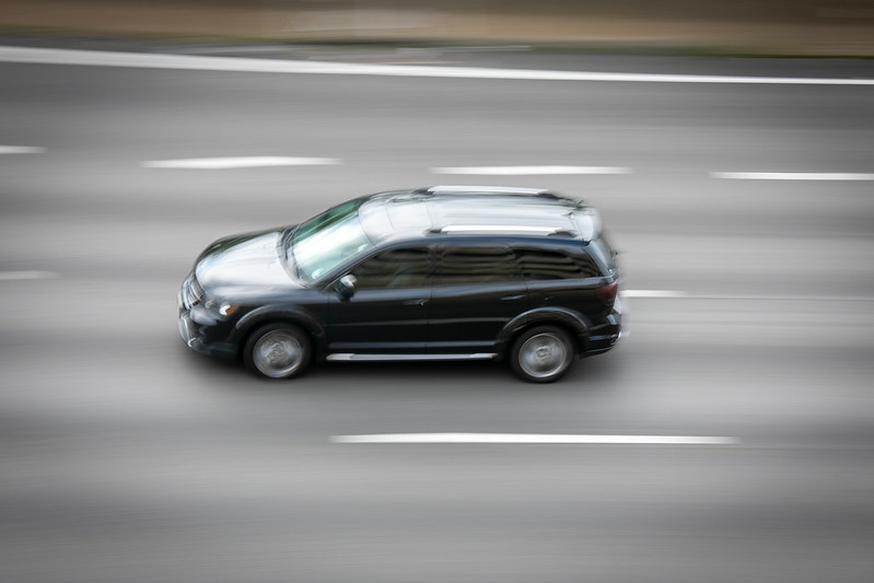 This images shows a lone vehicle moving fast with blurred background 