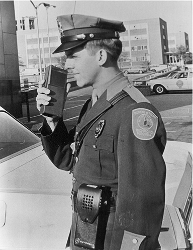 Officer uses a walkie-talkie in 1966