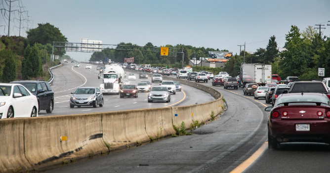 This image shows lots of traffic along the interstate in both directions