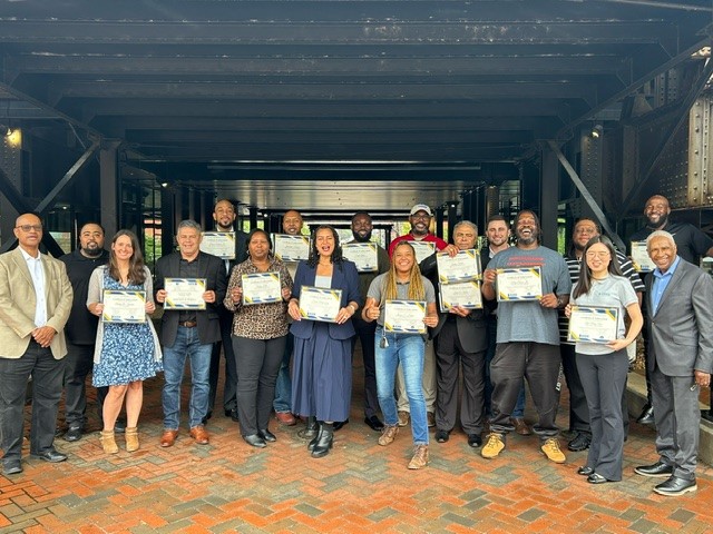 Graduates with their certificates