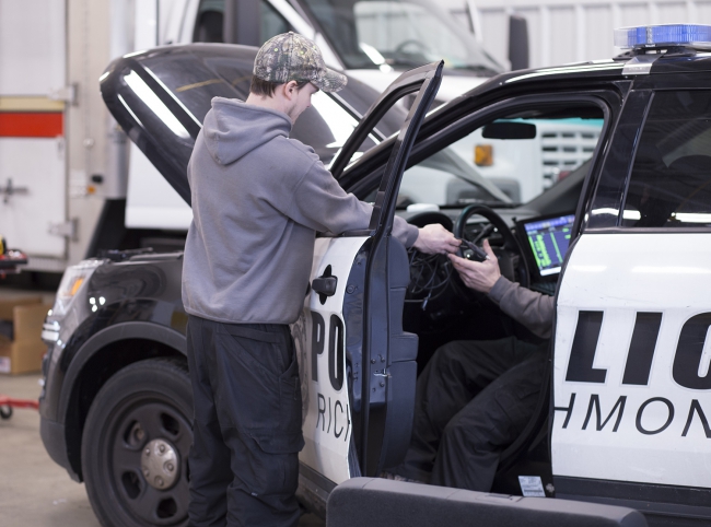 staff work on police car