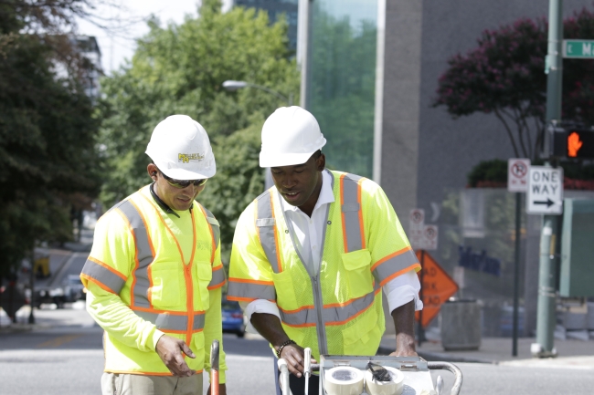 Mayor Stoney learns how to mark a crosswalk for pedestrian safety.